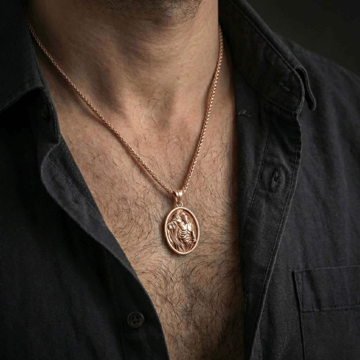 Rose gold plated Saint Sebastian pendant necklace worn on the neck, presented in a close-up lifestyle shot with a refined masculine aesthetic.