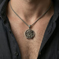 Load image into Gallery viewer, Oxidized Jesus crown of thorns pendant worn on the neck in a lifestyle jewelry shot, styled against the chest for a bold and devotional look
