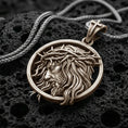 Load image into Gallery viewer, Bronze Jesus crown of thorns pendant with side profile portrait and flowing hair detail displayed on dark volcanic rock in a close-up luxury jewelry composition
