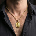 Load image into Gallery viewer, Gold plated Saint Jude necklace with haloed saint motif worn on the neck in a premium lifestyle composition with classic Christian jewelry styling
