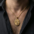 Load image into Gallery viewer, Gold plated Saint Christopher necklace with traveler saint motif worn on the neck in a premium lifestyle composition with classic Christian jewelry styling
