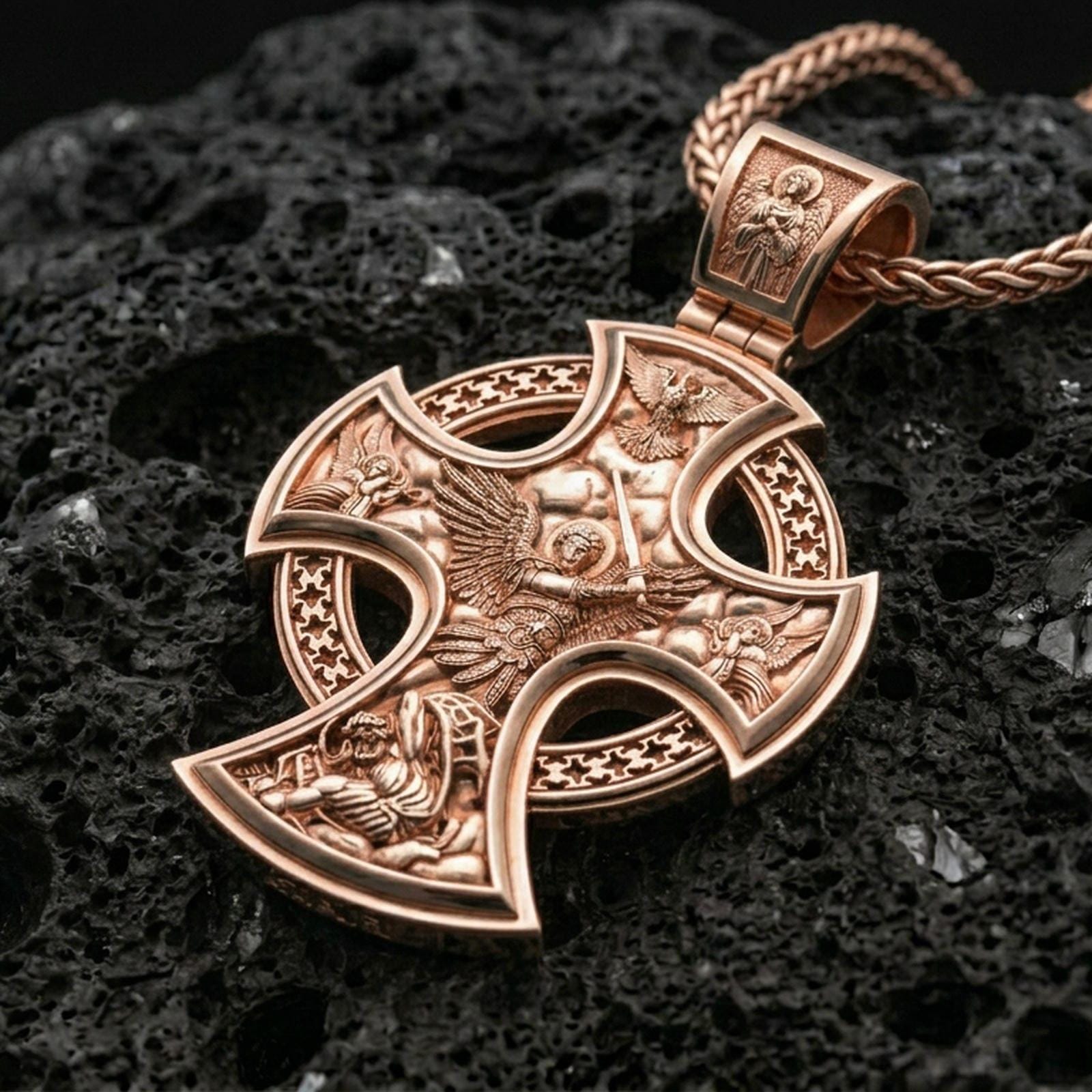 Rose gold plated Archangel Michael amulet with elaborate cross form, angelic relief details, and symbolic devotional design resting on volcanic rock in an elegant close-up product presentation