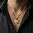 Load image into Gallery viewer, Gold plated Lion of Judah necklace with circular lion emblem worn on the neck in a premium lifestyle composition with strong Christian jewelry styling
