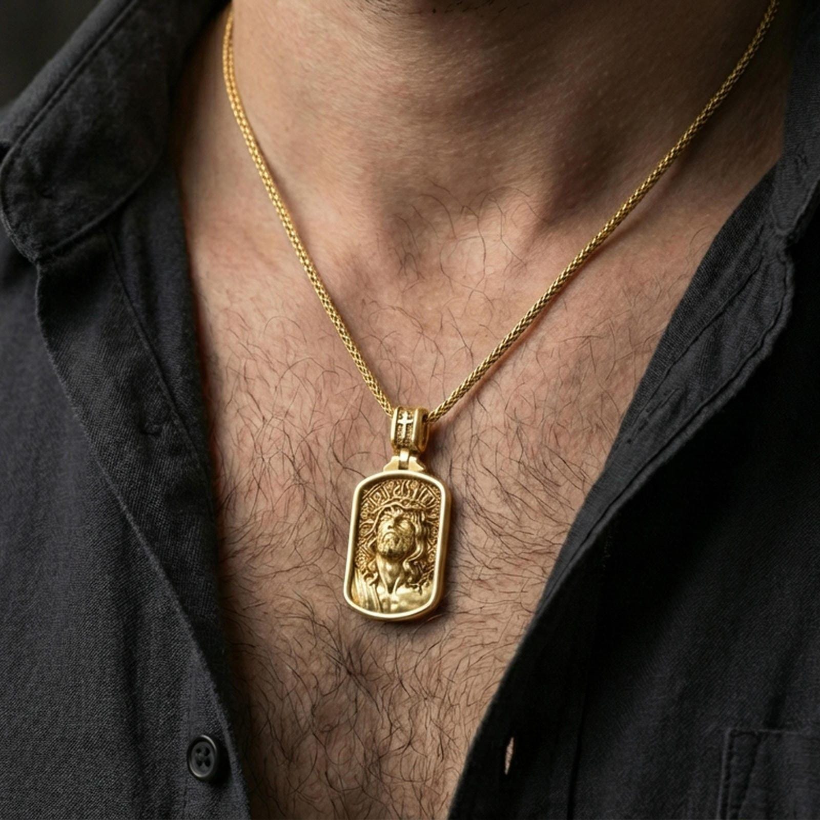 Gold plated Jesus Christ pendant with crown of thorns and sculpted portrait worn on the neck in a premium lifestyle composition with timeless Christian jewelry styling