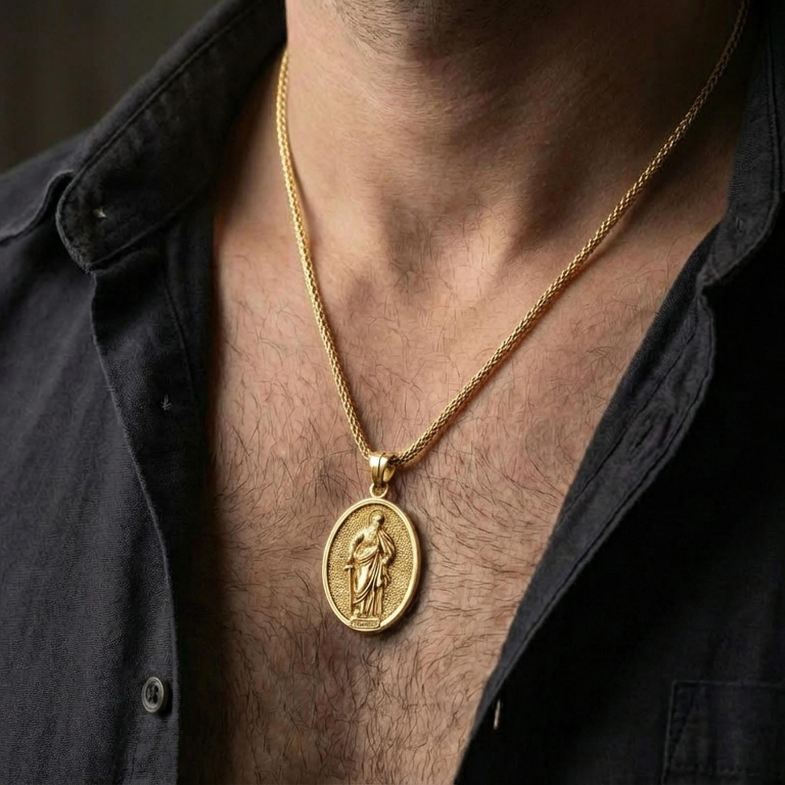 Gold plated Saint Paul necklace with devotional saint figure and sword symbol worn on the neck in a premium lifestyle composition with classic Christian jewelry styling