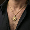 Load image into Gallery viewer, Gold plated Om necklace with round mandala design and sacred symbol worn on the neck in a premium lifestyle composition with elegant spiritual jewelry styling
