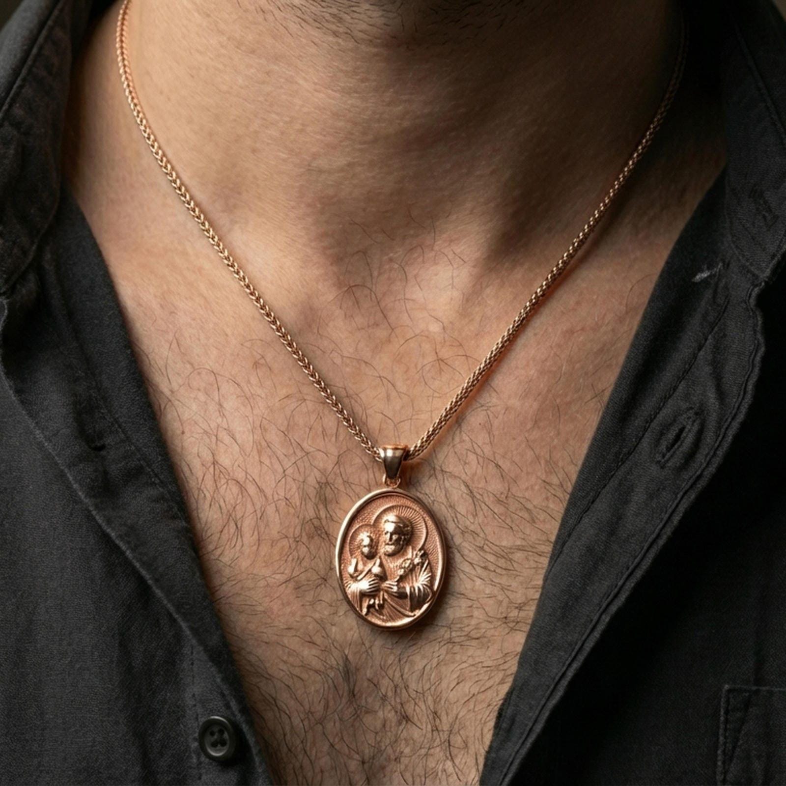 Rose gold plated Saint Joseph pendant with Child Jesus and haloed devotional portrait worn on the neck in a refined lifestyle shot with a warm and elegant presentation