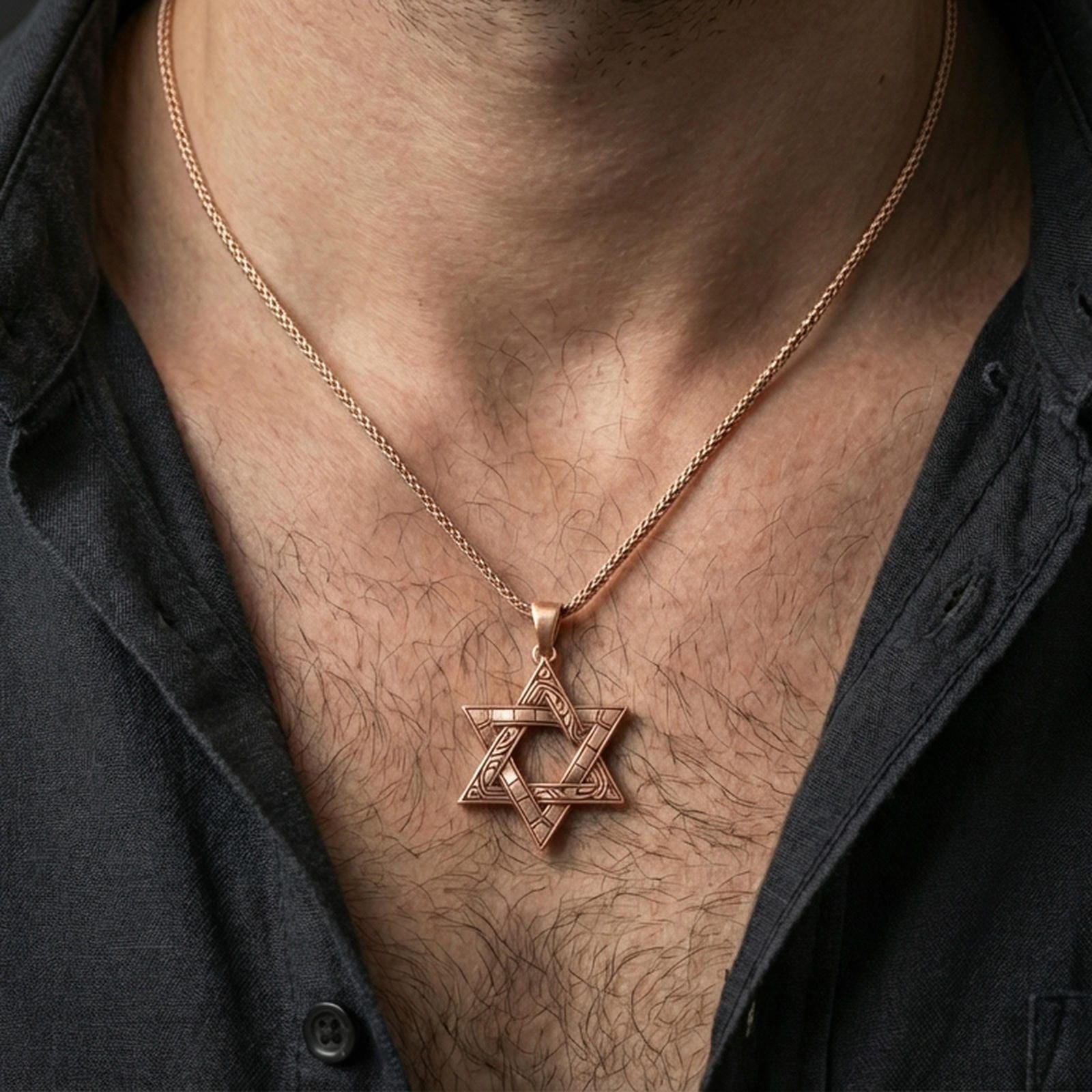 Rose gold plated Jewish Star of David necklace with engraved geometric pattern and elegant symbolic form worn on the neck in a refined lifestyle shot with a warm and polished presentation