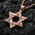 Load image into Gallery viewer, Rose gold plated Jewish Star of David necklace with detailed linework, interwoven symbolic shape, and elegant six-pointed silhouette resting on volcanic rock in an elegant close-up product presentation
