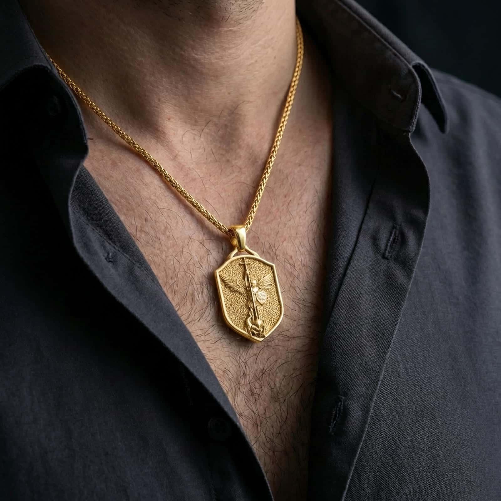 Gold plated Saint Michael shield pendant necklace worn on the neck, captured on a human model in a premium dark-toned lifestyle frame.