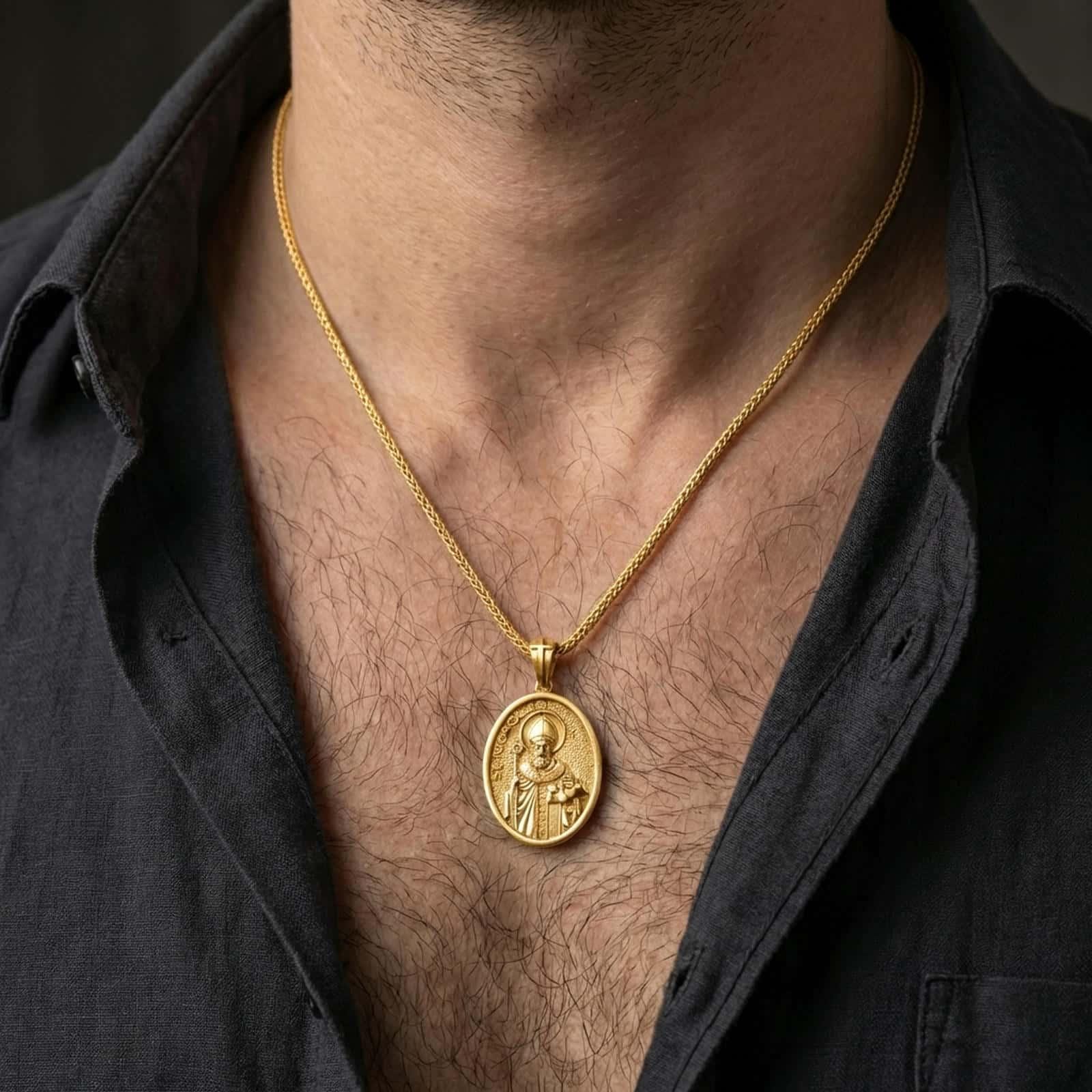 Gold plated Saint Nicholas pendant necklace worn on the neck, captured on a human model in a premium dark-toned lifestyle frame.