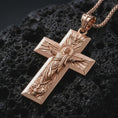 Load image into Gallery viewer, Rose gold plated Jesus Ascension cross pendant necklace on dark volcanic rock, photographed in a detailed premium studio macro view.
