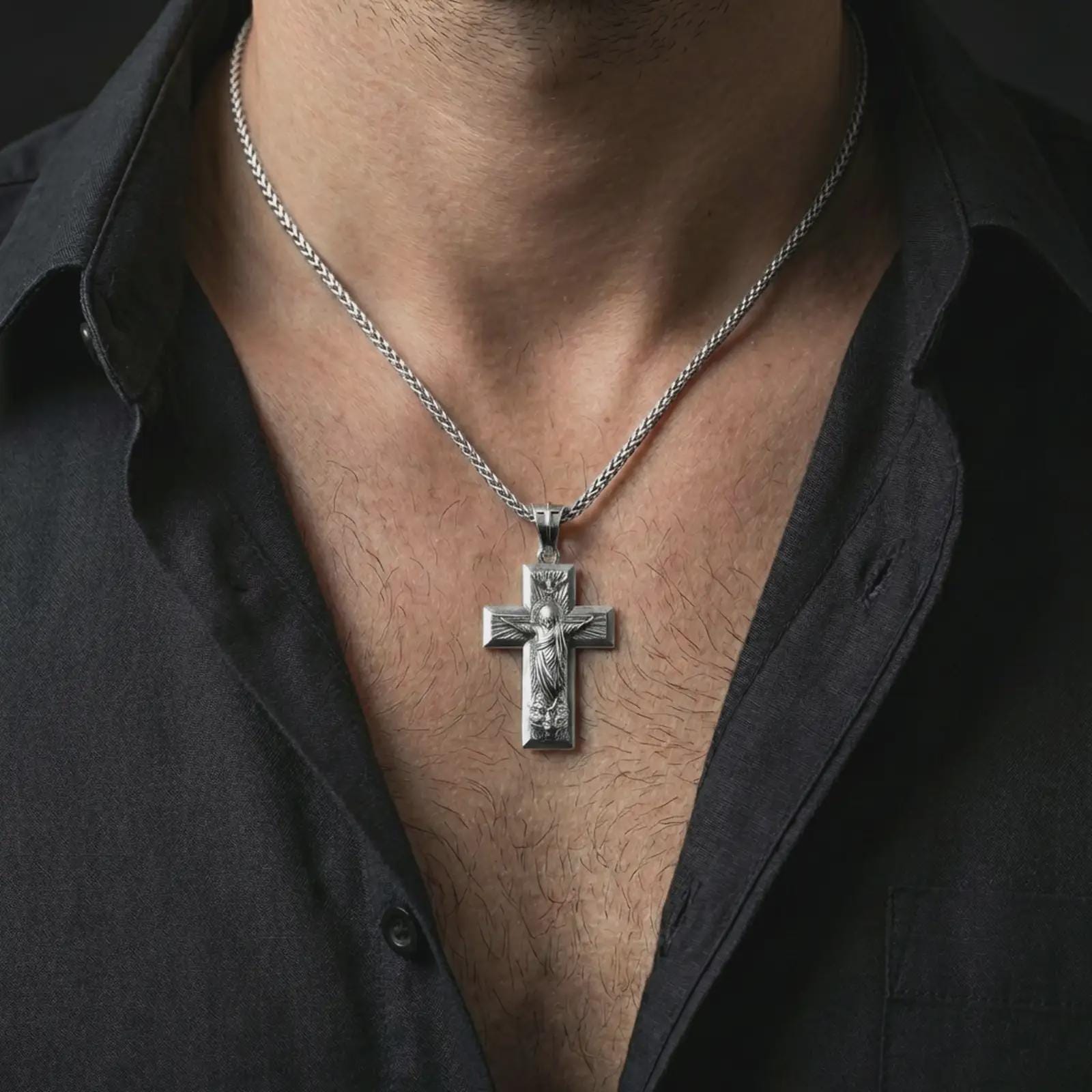 Polished silver Jesus Ascension cross pendant necklace worn on the neck, shown against the chest in a clean and elegant everyday wear composition.