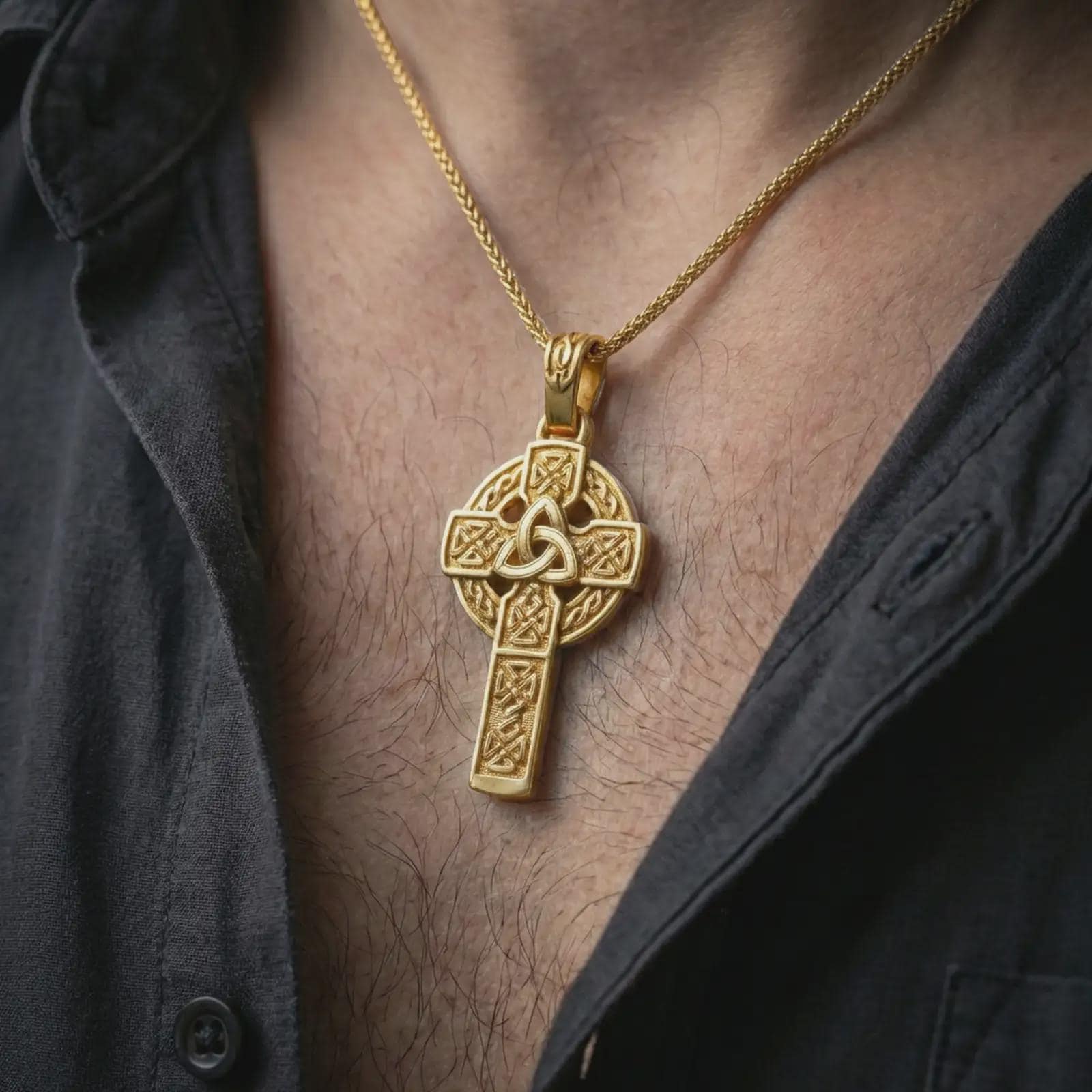 Gold plated Celtic cross pendant necklace worn on the neck, captured on a human model in a premium dark-toned lifestyle frame.