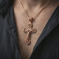Load image into Gallery viewer, Rose gold plated Saint Benedict crucifix necklace worn on the neck, presented in a close-up lifestyle shot with a refined masculine aesthetic.
