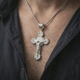 Load image into Gallery viewer, Polished silver Saint Benedict crucifix necklace worn on the neck, shown against the chest in a clean and elegant everyday wear composition.

