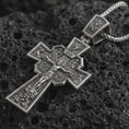 Load image into Gallery viewer, Sterling silver Orthodox cross pendant necklace with an oxidized finish resting on textured volcanic rock, captured in a close-up premium studio composition.
