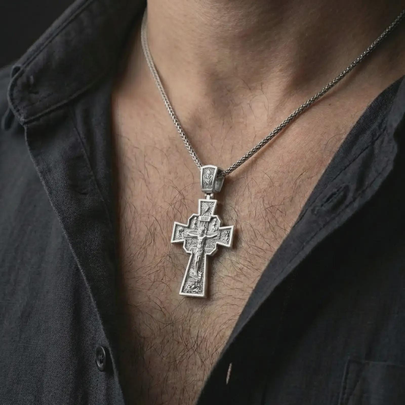 Polished silver Orthodox cross pendant necklace worn on the neck, shown against the chest in a clean and elegant everyday wear composition.
