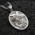 Load image into Gallery viewer, Polished silver Jesus carrying cross pendant necklace displayed on black volcanic rock, shown in a refined macro product shot with detailed sacred figure and cross relief.
