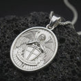 Load image into Gallery viewer, Polished silver Saint Michael Archangel pendant necklace displayed on black volcanic rock, shown in a refined macro product shot with detailed winged guardian figure and shield relief.
