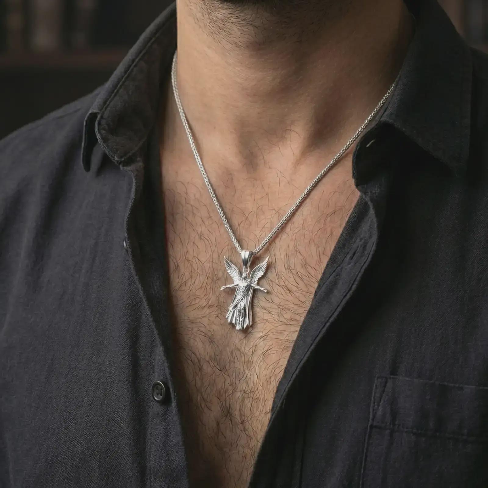Polished silver Archangel Michael pendant necklace worn on the neck, shown against the chest in a clean and elegant everyday wear composition.