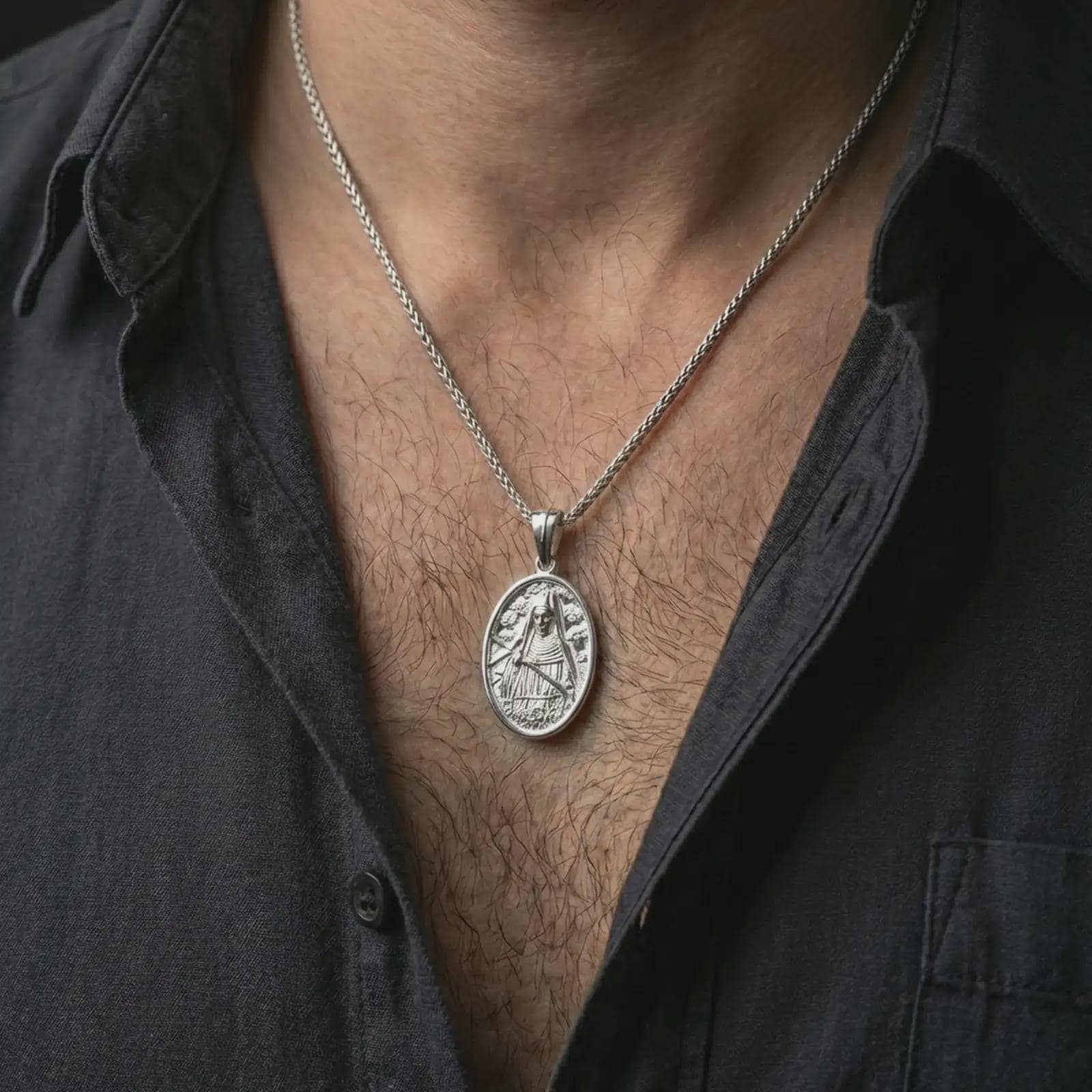Polished silver Saint Rita pendant necklace worn on the neck, shown against the chest in a clean and elegant everyday wear composition.
