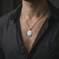 Load image into Gallery viewer, Polished silver Saint Martin of Tours pendant necklace worn on the neck, shown against the chest in a clean and elegant everyday wear composition.
