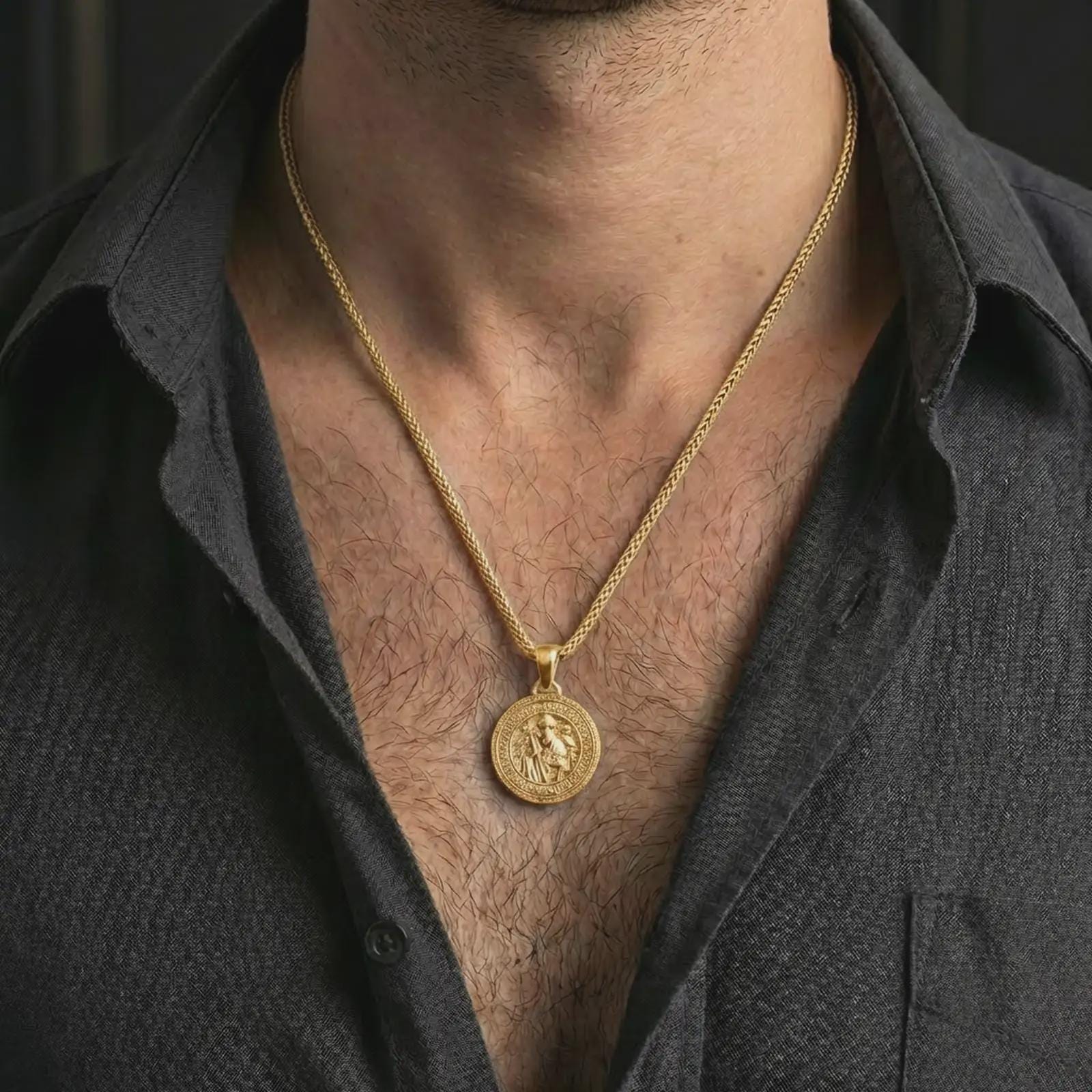 Gold plated Saint Benedict medal pendant necklace worn on the neck, captured on a human model in a premium dark-toned lifestyle frame.