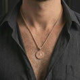 Load image into Gallery viewer, Rose gold plated Saint Benedict medal pendant necklace worn on the neck, presented in a close-up lifestyle shot with a refined masculine aesthetic.
