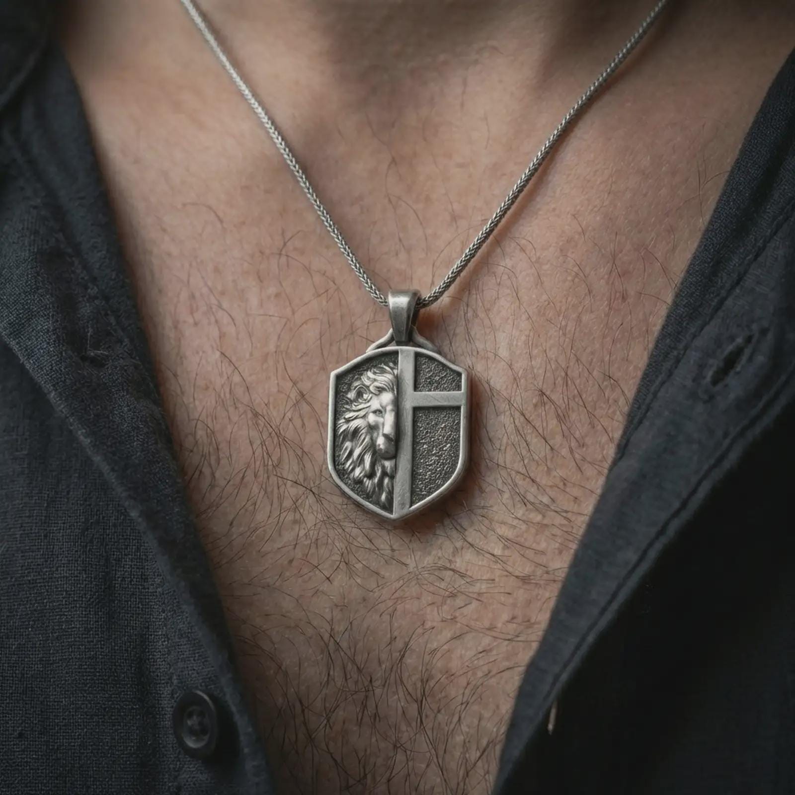 A 925 sterling silver lion cross pendant worn on the neck, oxidized finish enhancing the heraldic shield details.