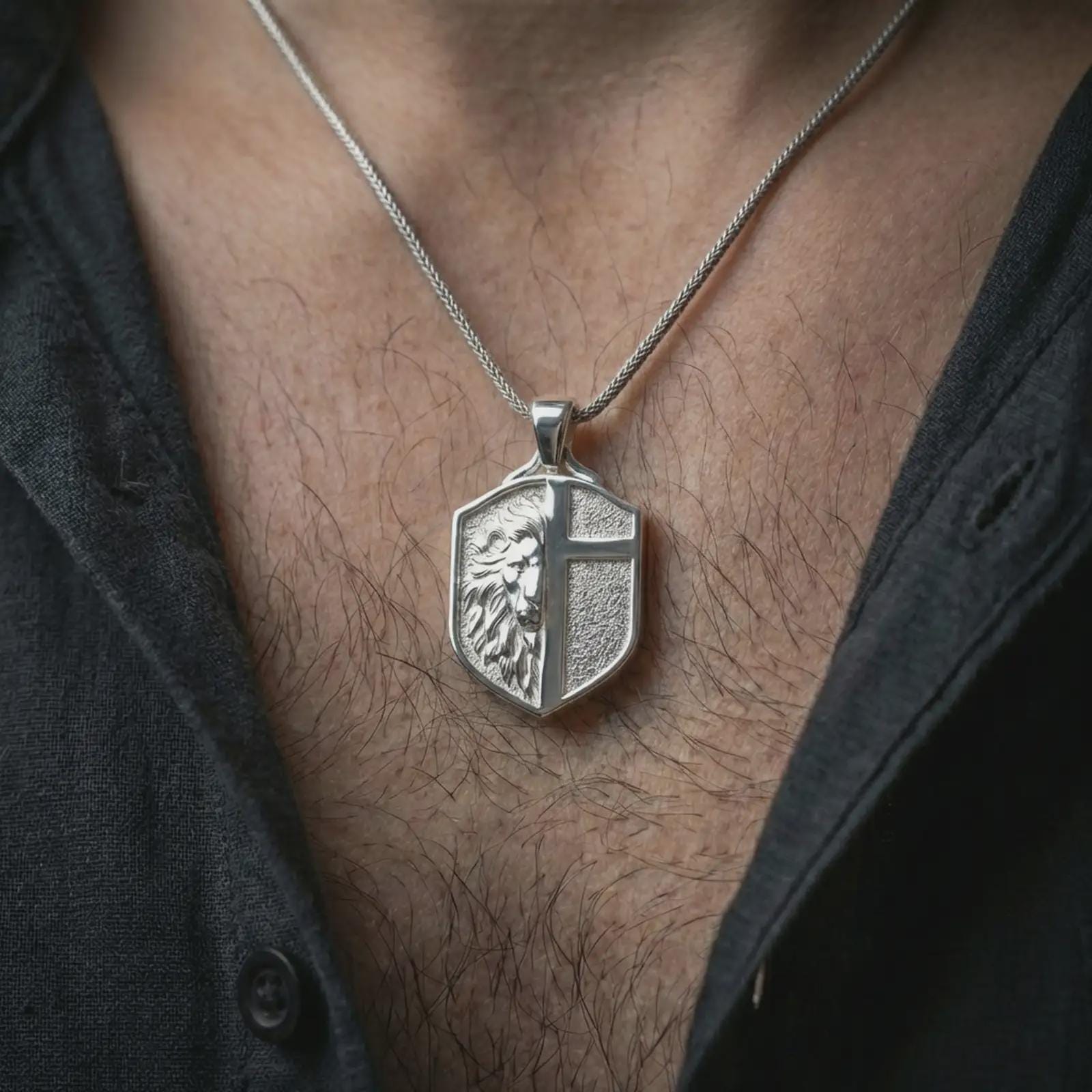 A polished 925 sterling silver shield necklace worn on the neck, lion and cross symbol styled as a modern talisman.