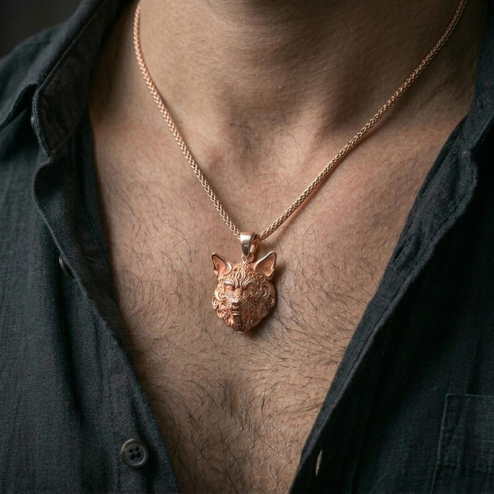 Rose gold plated wolf pendant with carved fur texture and fierce animal profile worn on the neck in a refined lifestyle shot with a warm and powerful presentation