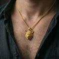 Load image into Gallery viewer, Gold plated wolf head pendant worn on the neck in a premium lifestyle composition with strong wildlife-inspired jewelry styling
