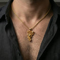Load image into Gallery viewer, Gold plated serpent pendant with coiled snake, apple accent, and organic branch motif worn on the neck in a premium lifestyle composition with strong symbolic jewelry styling
