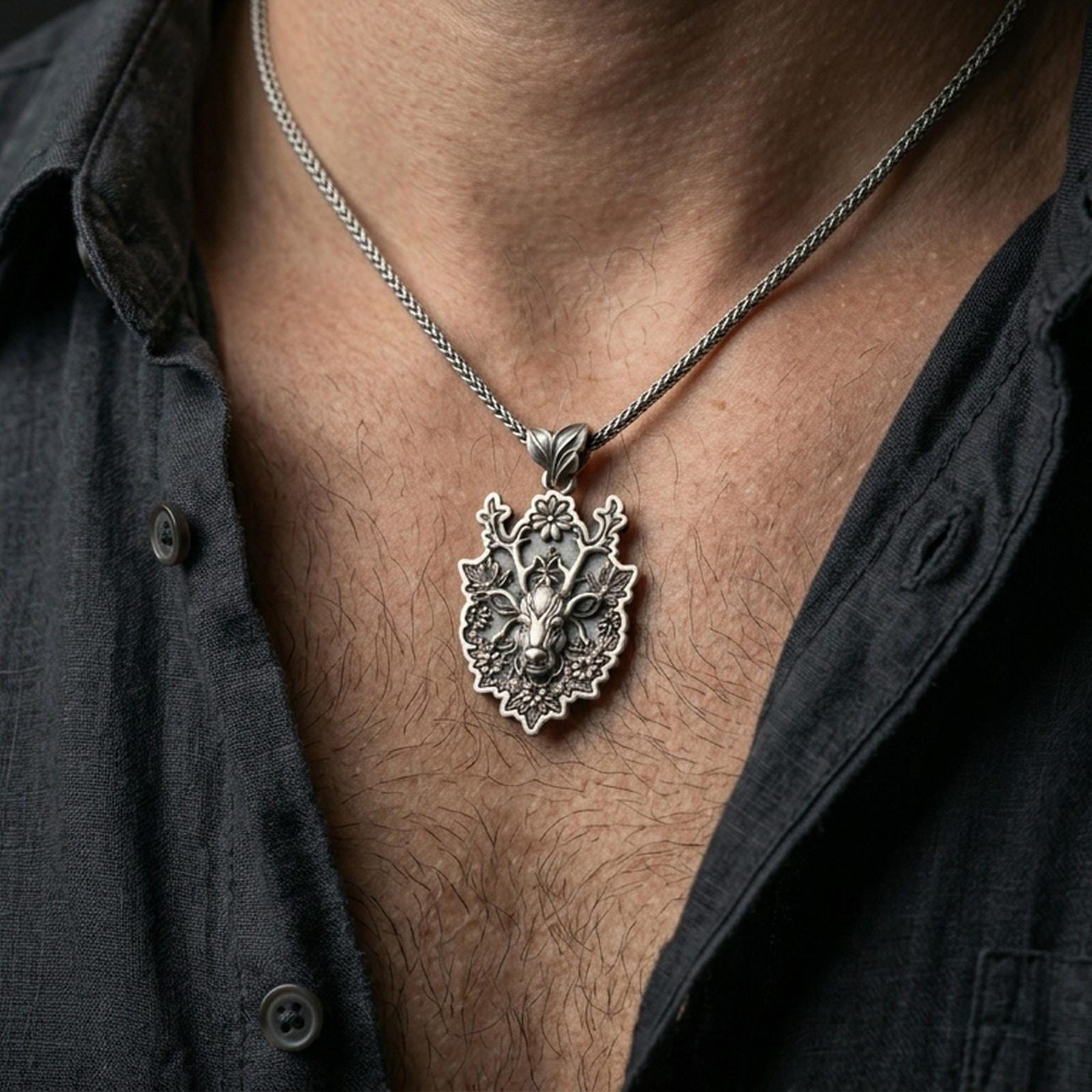 Oxidized deer pendant with floral antlers worn on the neck in a lifestyle jewelry shot, styled against the chest for a bold and nature-inspired statement look