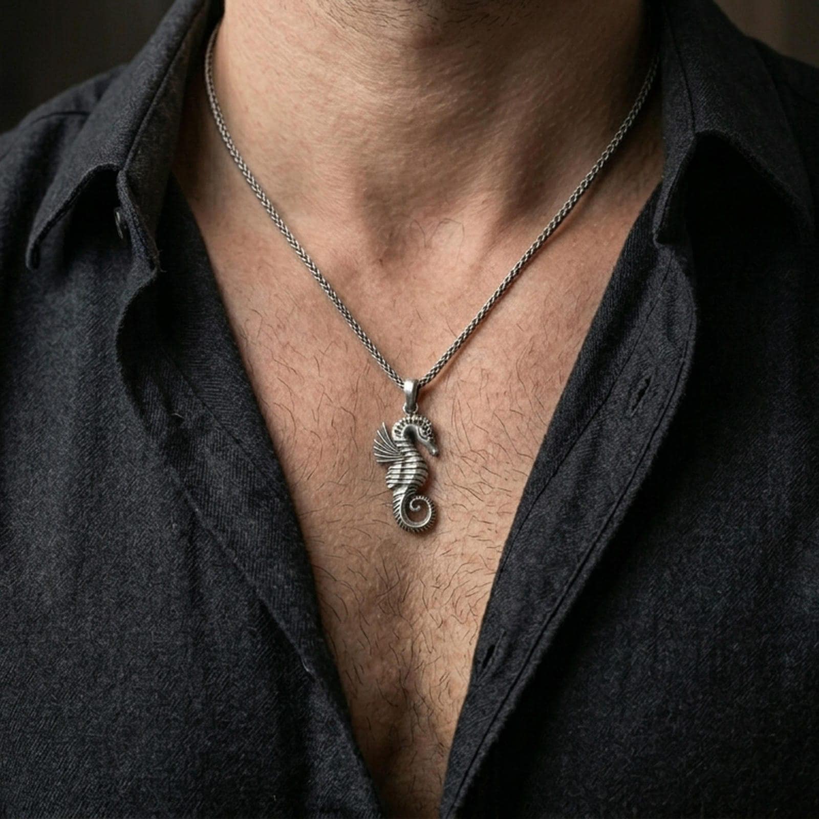 Oxidized seahorse pendant worn on the neck in a lifestyle jewelry shot, styled against the chest for a bold and ocean-inspired look