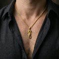 Load image into Gallery viewer, Gold plated seahorse pendant worn on the neck in a premium lifestyle composition with refined nautical jewelry styling
