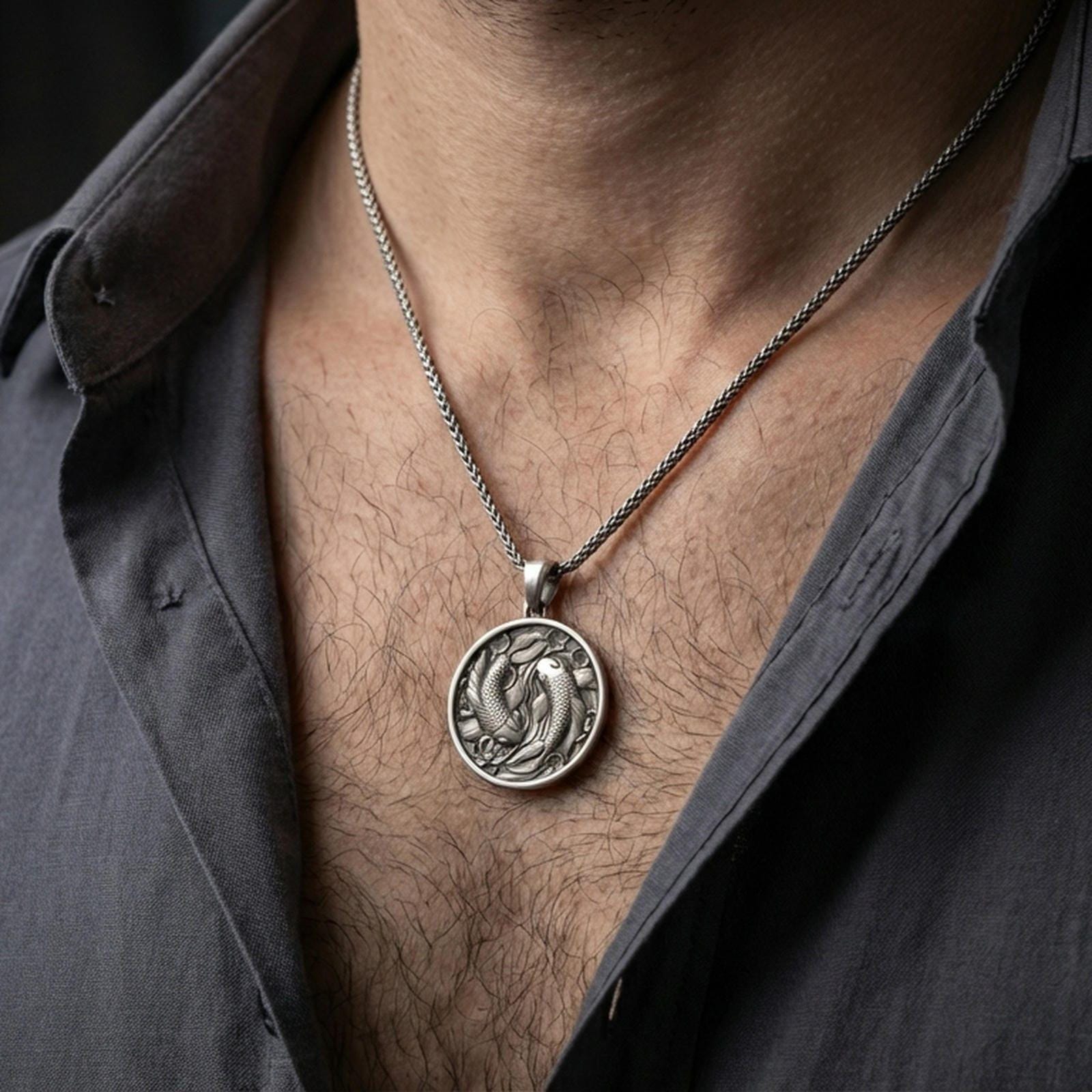 Oxidized koi fish pendant with twin fish motif worn on the neck in a lifestyle jewelry shot, styled against the chest for a balanced and nature-inspired look