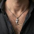 Load image into Gallery viewer, Oxidized origami seahorse pendant worn on the neck in a lifestyle jewelry shot, styled against the chest for a bold and modern ocean-inspired look

