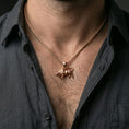Load image into Gallery viewer, Rose gold plated bull necklace with detailed bovine relief and elegant Taurus-style silhouette worn on the neck in a refined lifestyle shot with a warm and striking presentation
