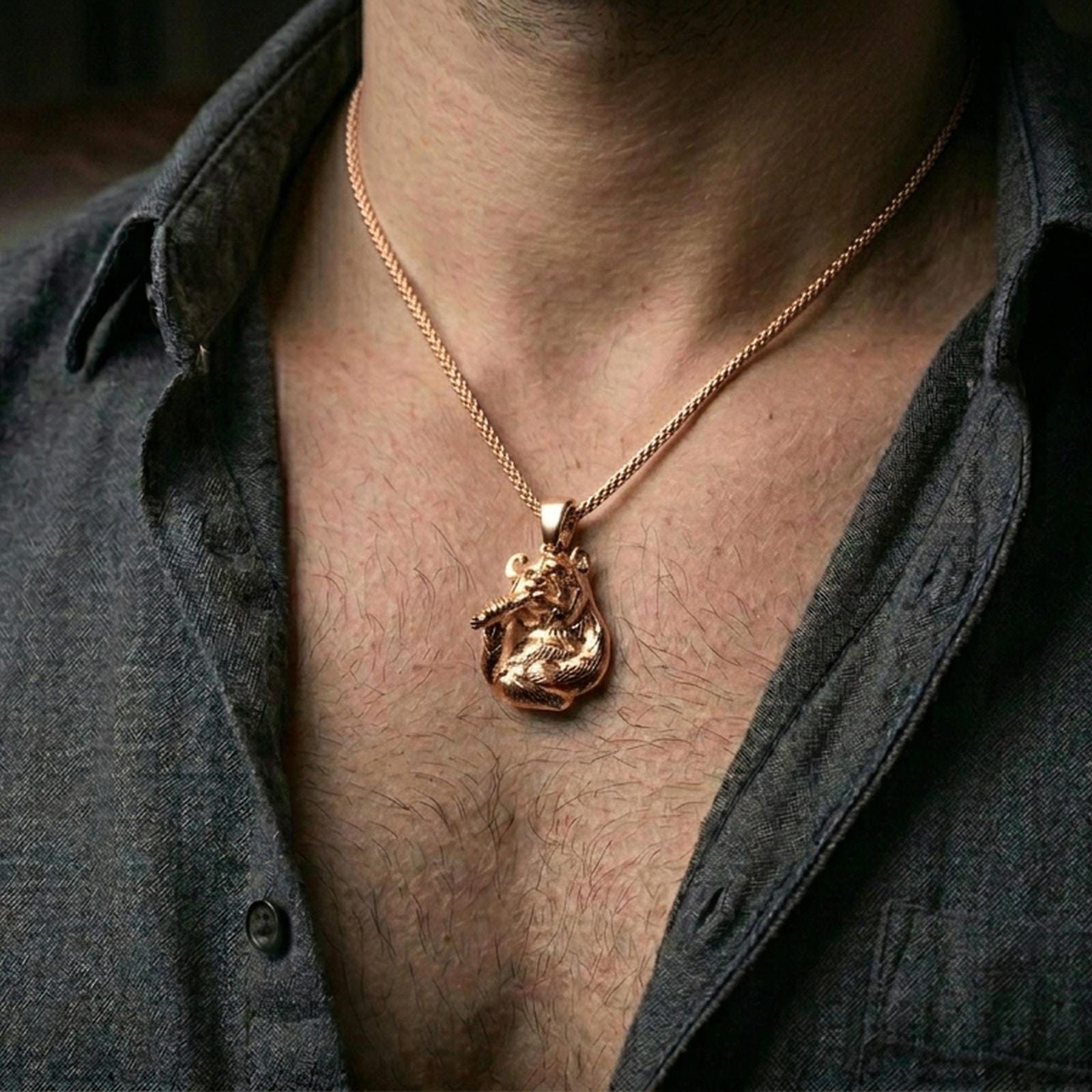 Gold plated panda pendant with realistic bear expression and bamboo accent worn on the neck in a premium lifestyle composition with refined animal jewelry styling
