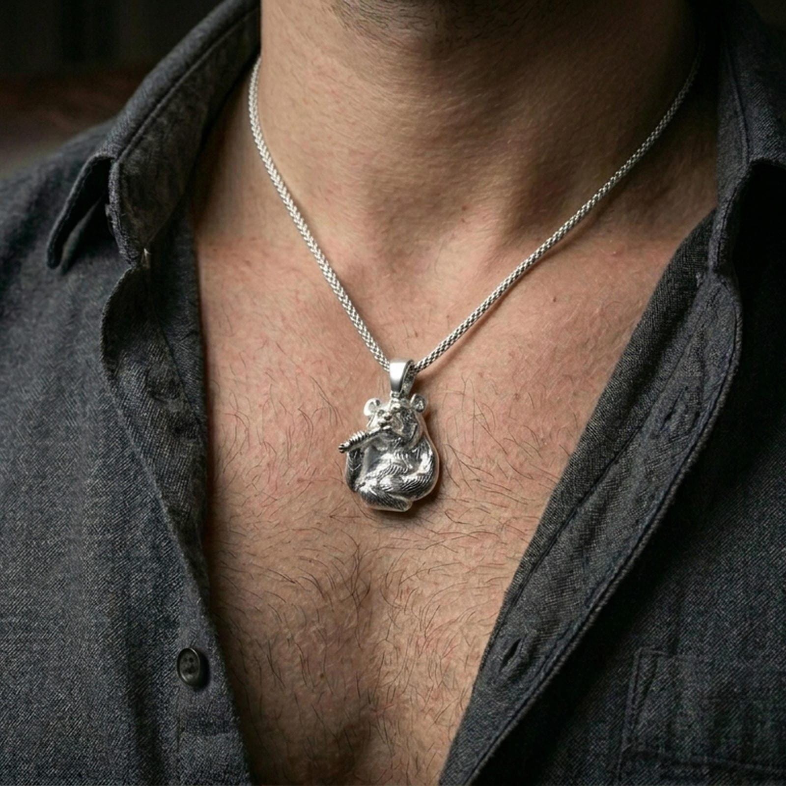 Polished silver panda necklace with textured fur relief and bamboo motif worn on the neck in a close lifestyle frame, highlighting the charming animal design and detailed sculptural form