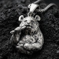 Load image into Gallery viewer, Oxidized panda pendant with detailed fur texture, bamboo stalk accent, and playful animal silhouette displayed on dark volcanic rock in a close-up luxury jewelry composition
