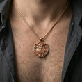 Load image into Gallery viewer, Rose gold plated owl necklace with sculpted owl relief, detailed plumage, and timeless circular design worn on the neck in a refined lifestyle shot with a warm and sophisticated presentation

