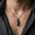 Load image into Gallery viewer, Oxidized alligator skull pendant with open jaw and reptile bone detailing worn on the neck in a lifestyle jewelry shot, styled against the chest for a bold and wild statement look
