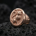 Load image into Gallery viewer, A rose gold plated feline signet ring on black volcanic rock, showcasing a minimalist cat motif with soft warm shine.
