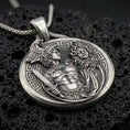 Load image into Gallery viewer, A 925 sterling silver Perseus and Medusa coin pendant on black volcanic stone with oxidized depth and Greek key border.

