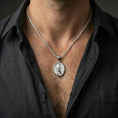 Load image into Gallery viewer, A polished 925 sterling silver Saint John the Evangelist necklace worn on the neck, oval saint medal on a chain for everyday wear.
