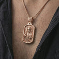 Load image into Gallery viewer, Rose gold plated Sacred Heart pendant necklace worn on the neck, presented in a close-up lifestyle shot with a refined masculine aesthetic.
