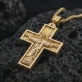 Load image into Gallery viewer, Gold plated Cristo Protetor cross pendant necklace presented on porous volcanic rock, highlighting the devotional cross form in a luxurious close-up jewelry image.
